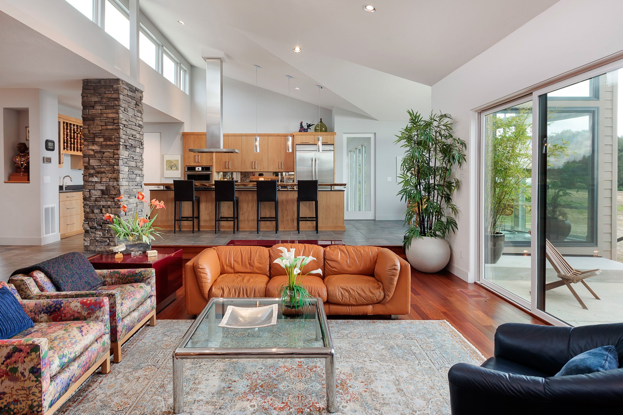 Open concept living room and kitchen with designed lighting